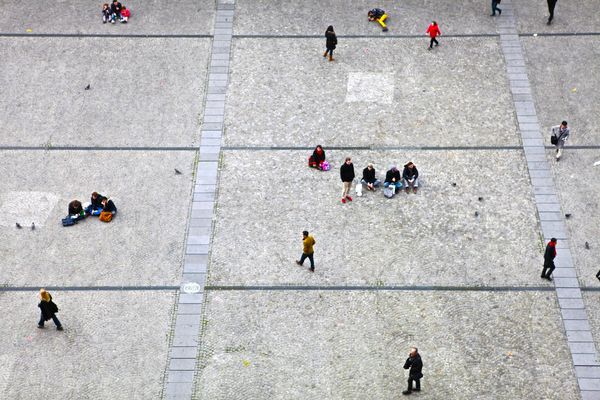 People walking between groups on a town square