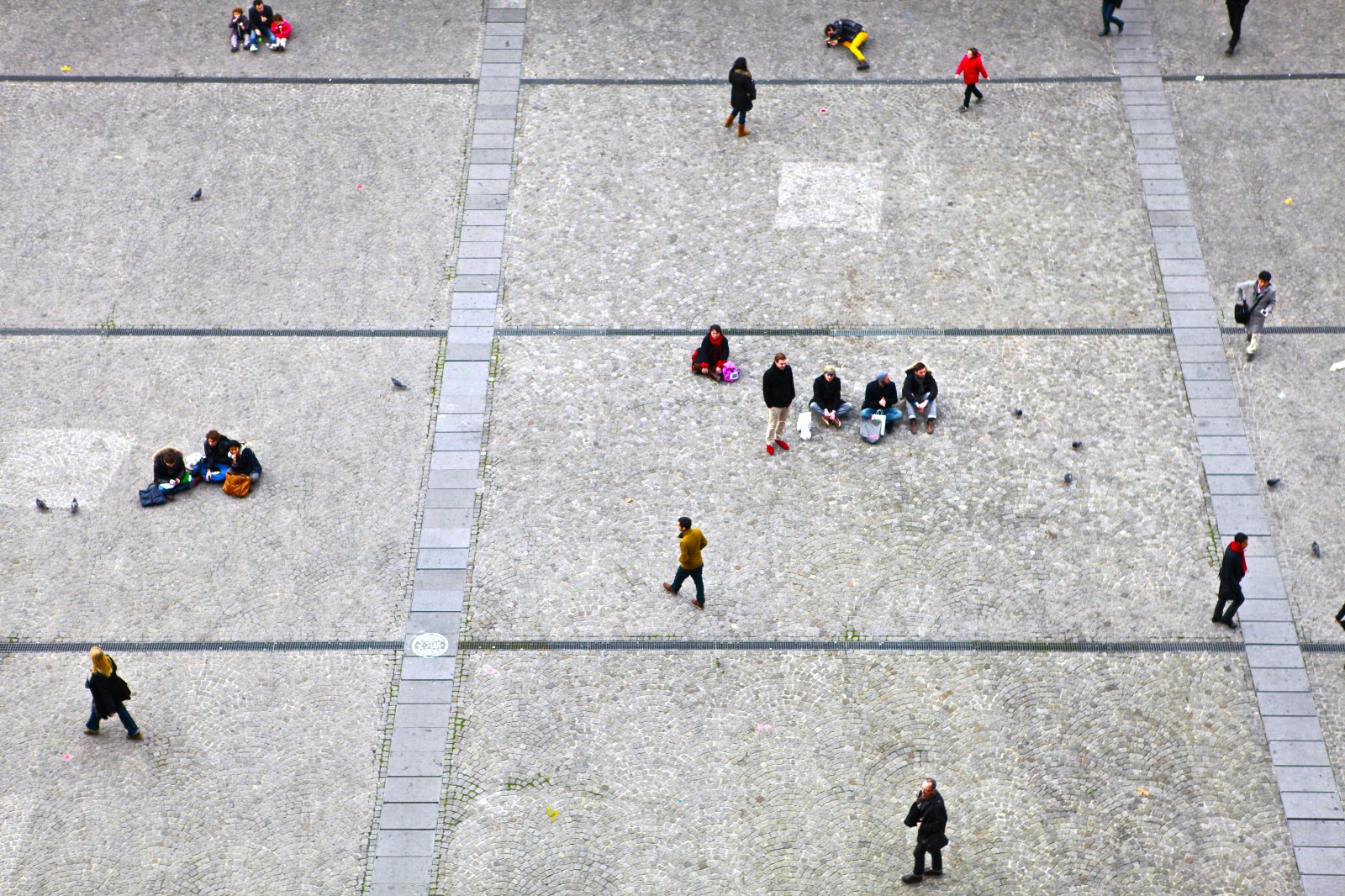 People walking between groups on a town square